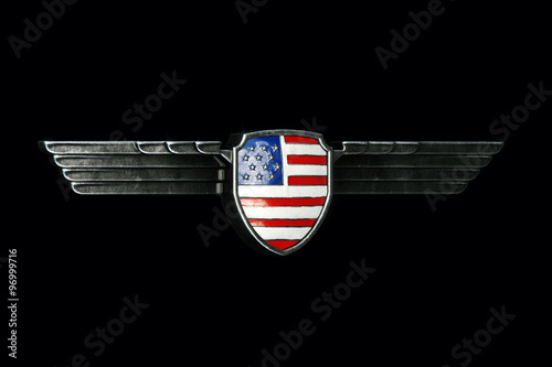 USA flag in metal wings frame isolated on black background. 