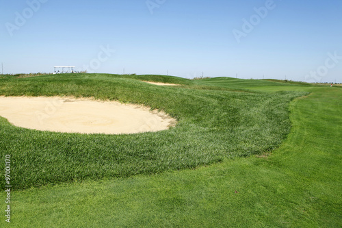 Sand bunker on the golf course © zhengzaishanchu
