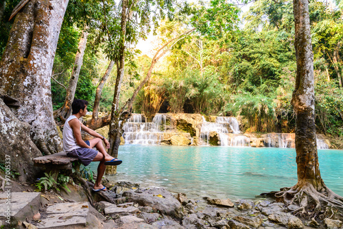 Man waiting for someone at rainforest waterfall  Tat Kuang Si Waterfall at Luang Prabang  Loas.