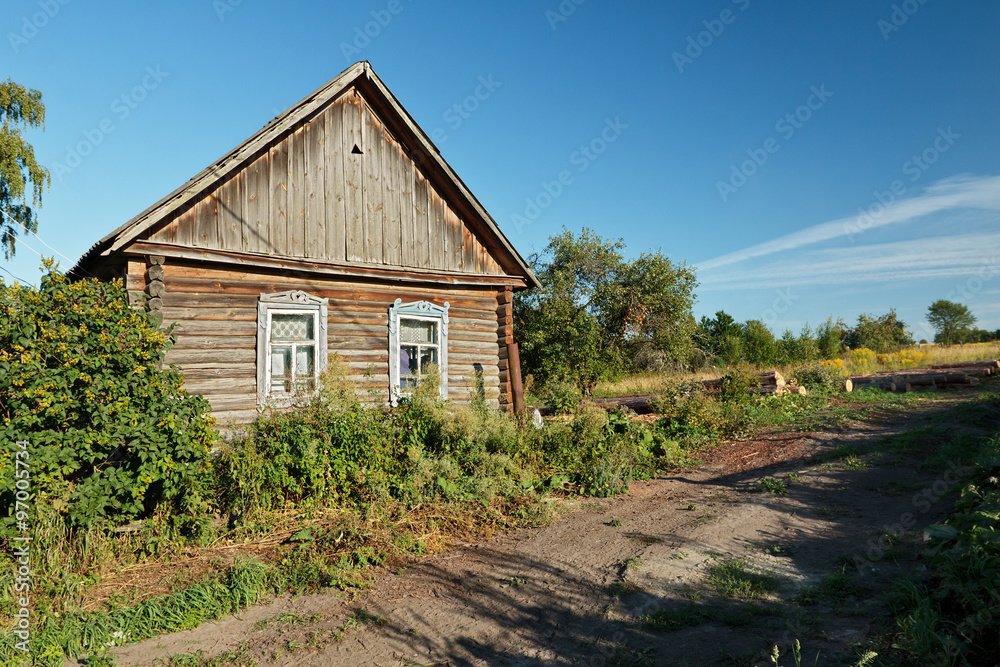 Timber house in Russian countryside near unsurfaced road