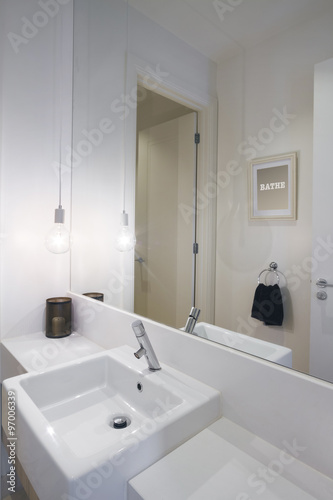 Close up of powder room basin tap and pendant lighting