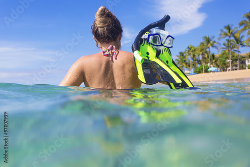 Woman snorkeling in the ocean at a tropical island resort