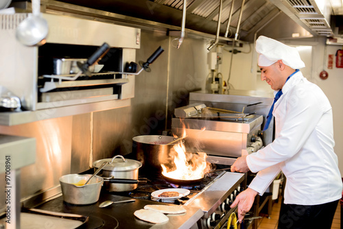 Chef preparing cuisine in hotel kitchen