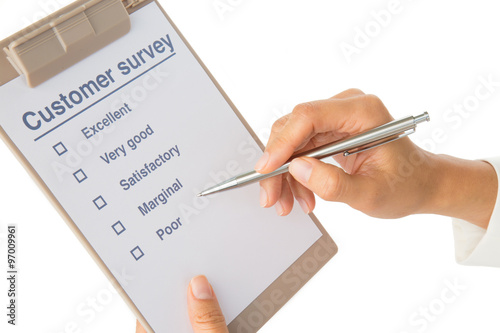 Hand fills out customer survey