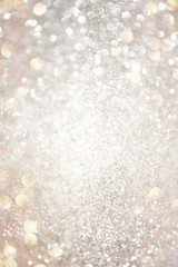 glitter vintage lights background. gold, silver, and white. de-focused