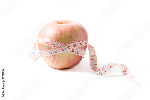 Measuring tape wrapped around apple as a symbol of diet.