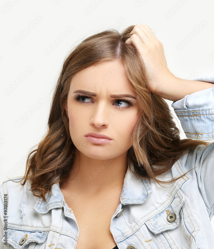 Portrait of worried young woman with her hand on forehead. Portrait of worried young woman with her hand on forehead.