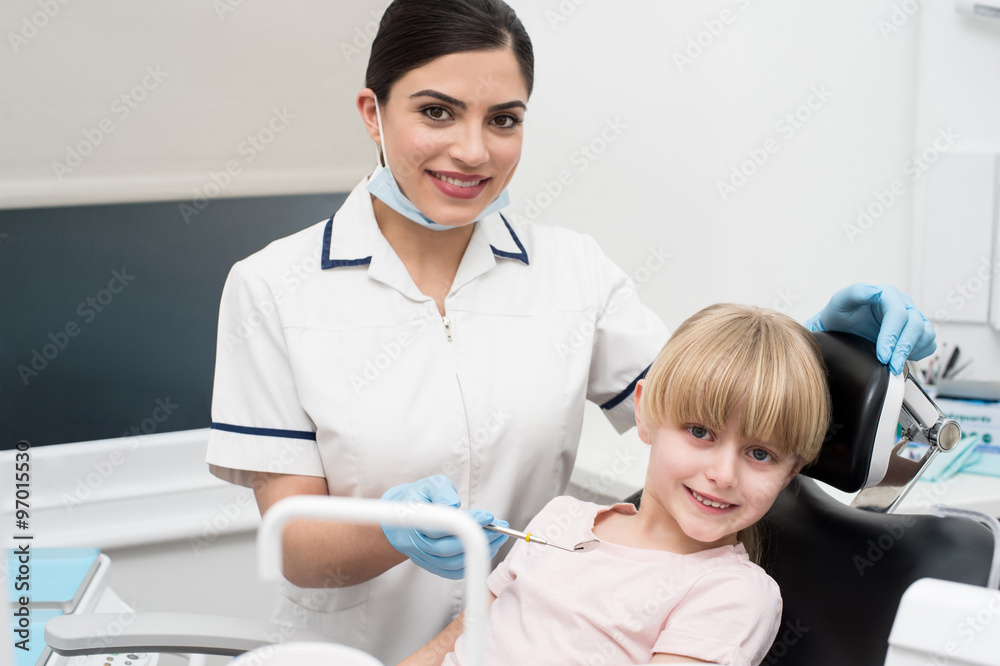 Fototapeta premium Cute girl child at dental clinic
