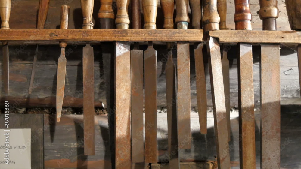 Different sizes of chisels hanging on the wooden tool box for carpenters Different sizes of chisels hanging on the wooden tool box for carpenters