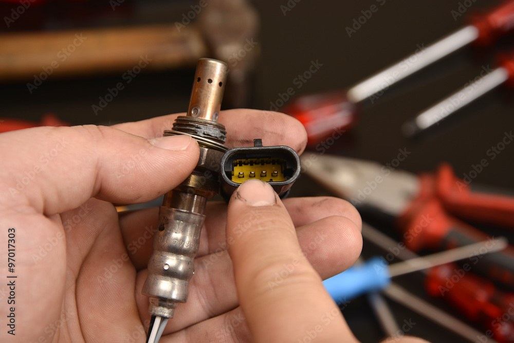 Fototapeta premium mechanic illustrates the connector for oxygen sensor