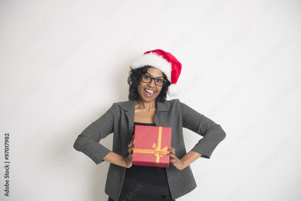 Young African American woman wearing a santa hat holding gift bo Young African American woman wearing a santa hat holding gift bo