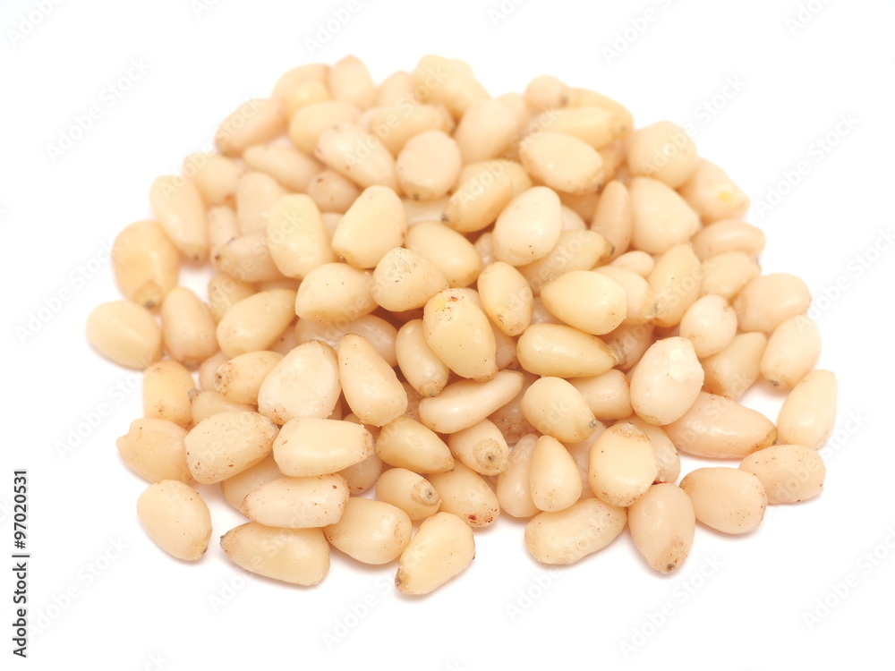 Peeled pine nuts on a white background Peeled pine nuts on a white background