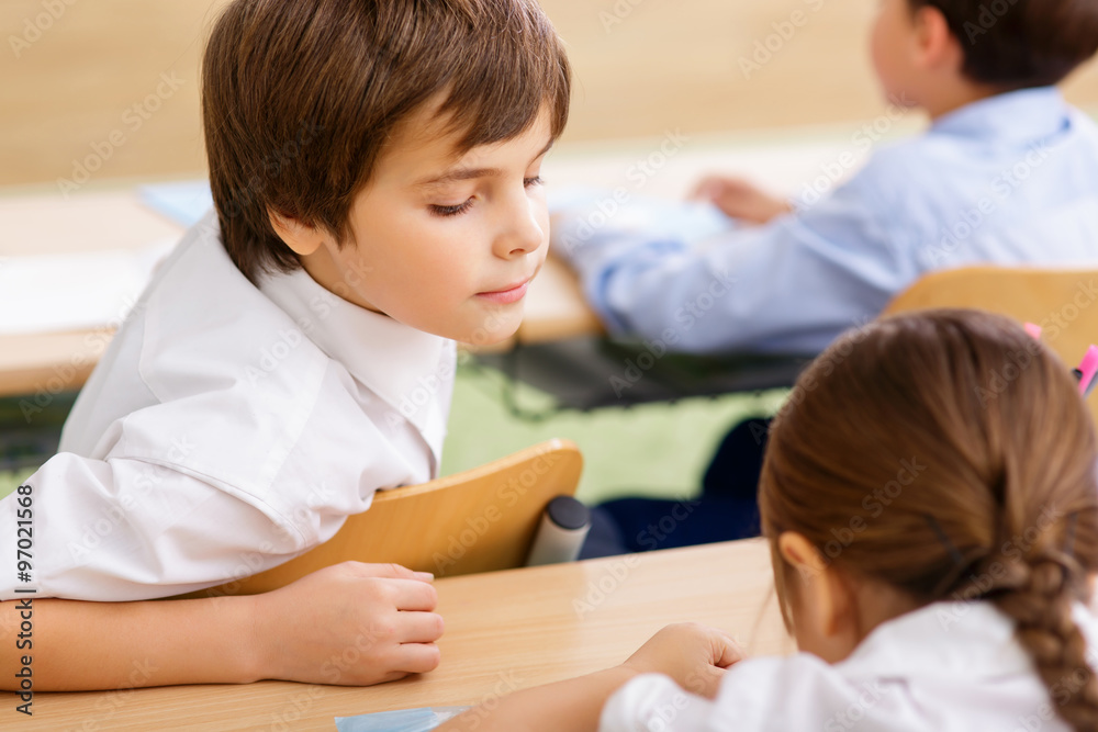 Little boy peeks at other notes. Little boy peeks at other notes.