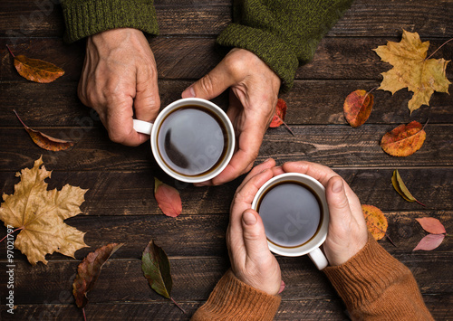 Old people hands. Closeup. The senior people hand holding cofee cup