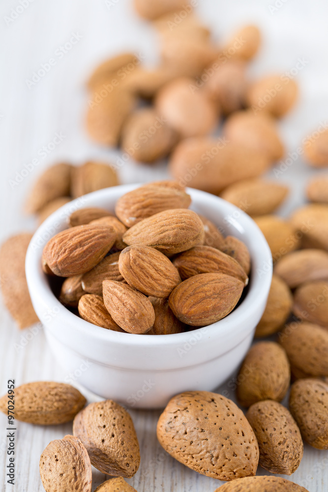 almonds on wooden surface almonds on wooden surface