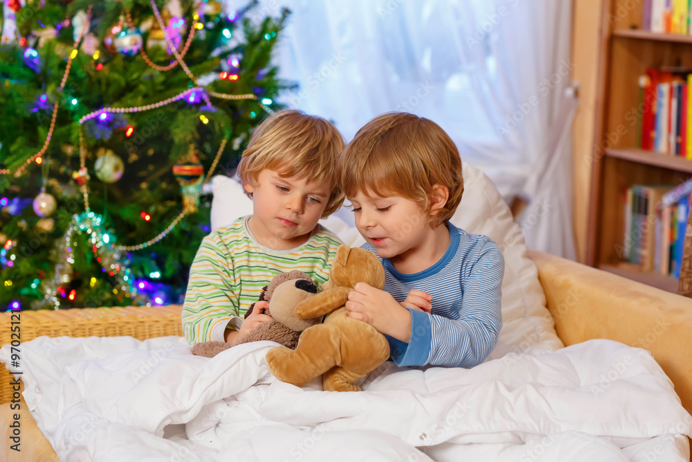 Two little sibling boys playing toys on Christmas Two little sibling boys playing toys on Christmas