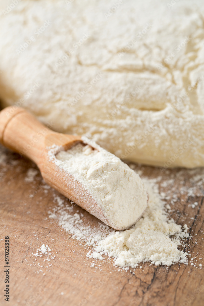 scoop of wheat flour and freshly prepared dough scoop of wheat flour and freshly prepared dough