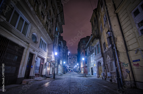 Bucharest, Romania – August 23, 2014: Night street scene in Bucharest old city. © agcreativelab
