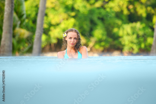 Woman relaxing in swimming pool