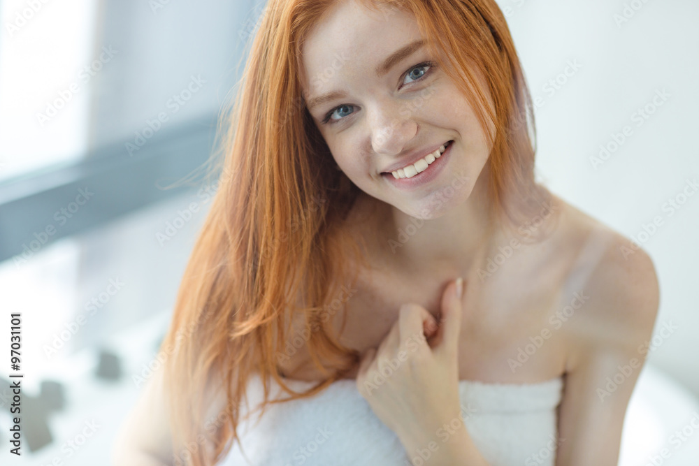 Smiling redhead woman looking at camera