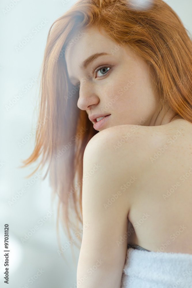 Redhead woman looking away in bathroom Redhead woman looking away in bathroom