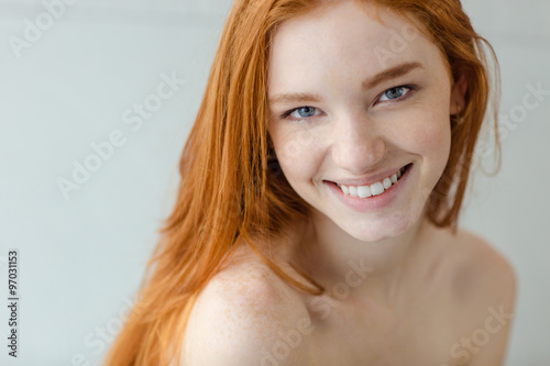 Smiling redhead woman looking at camera photo