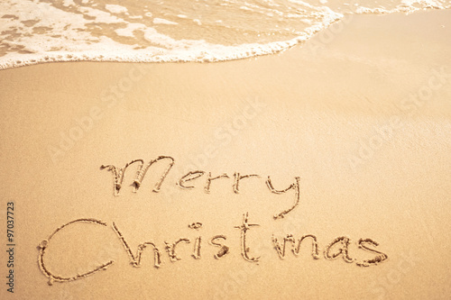 merry christmas written on the beach