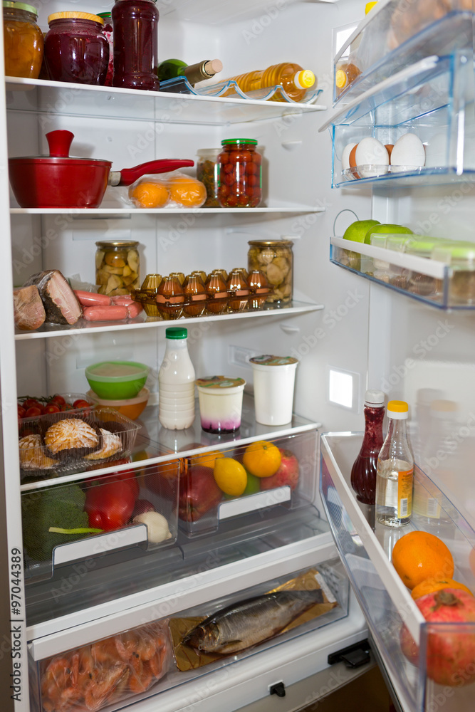 Domestic refrigerator full of a variety of foods