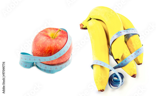 Banana and apple wrapped in measuring tape