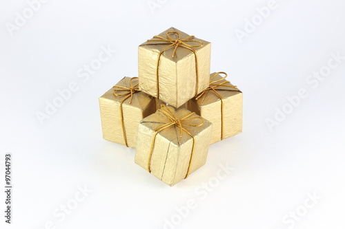 Gift box wrap gold paper with gold ribbon and isolated background 