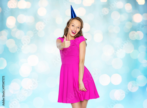 happy young woman or teen girl in party cap
