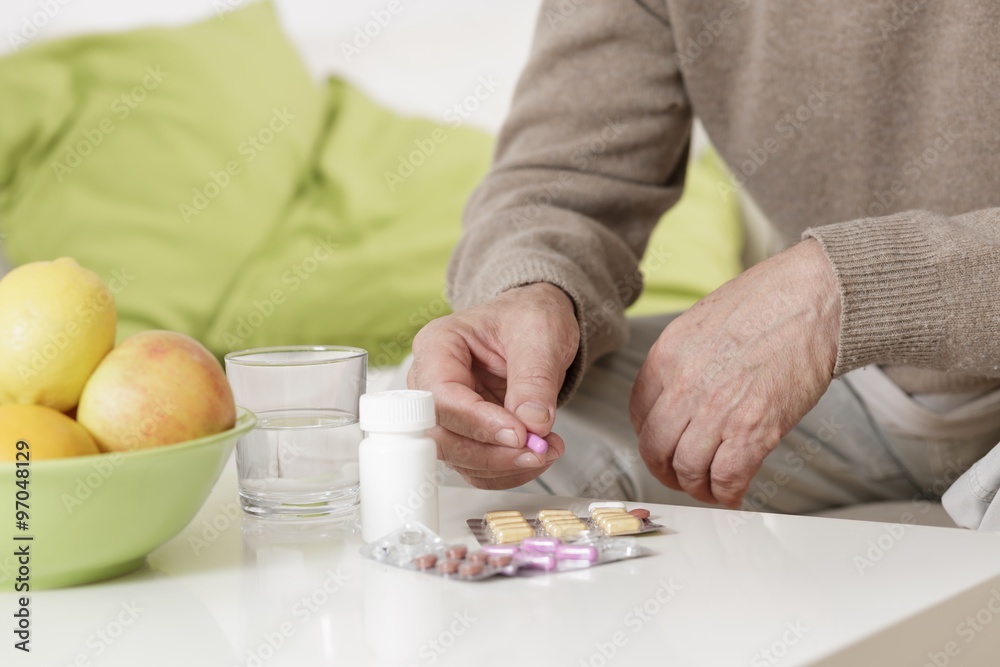 Old man taking pills Old man taking pills