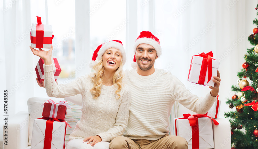 Fototapeta premium happy couple at home with christmas gift boxes