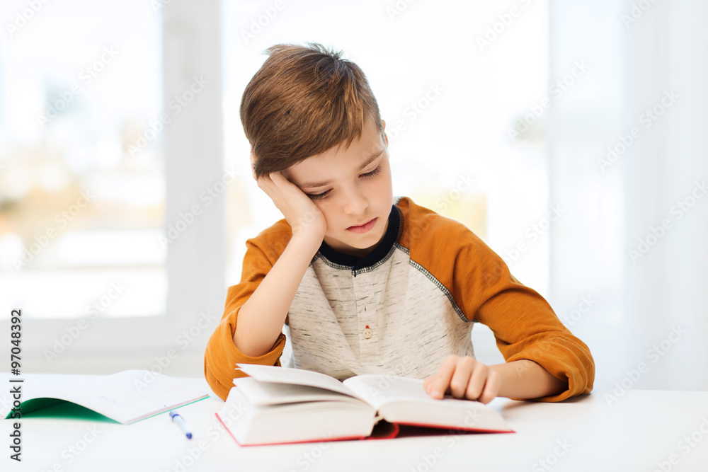 student boy reading book or textbook at home student boy reading book or textbook at home