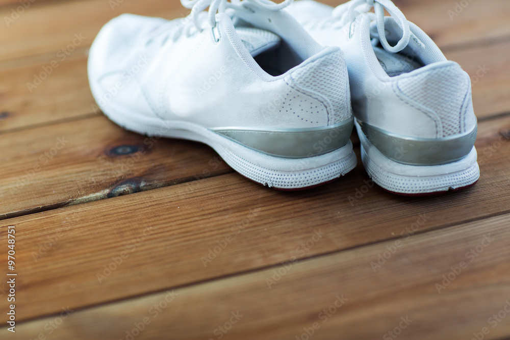 close up of sneakers on wooden floor close up of sneakers on wooden floor