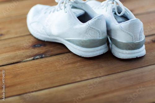 close up of sneakers on wooden floor