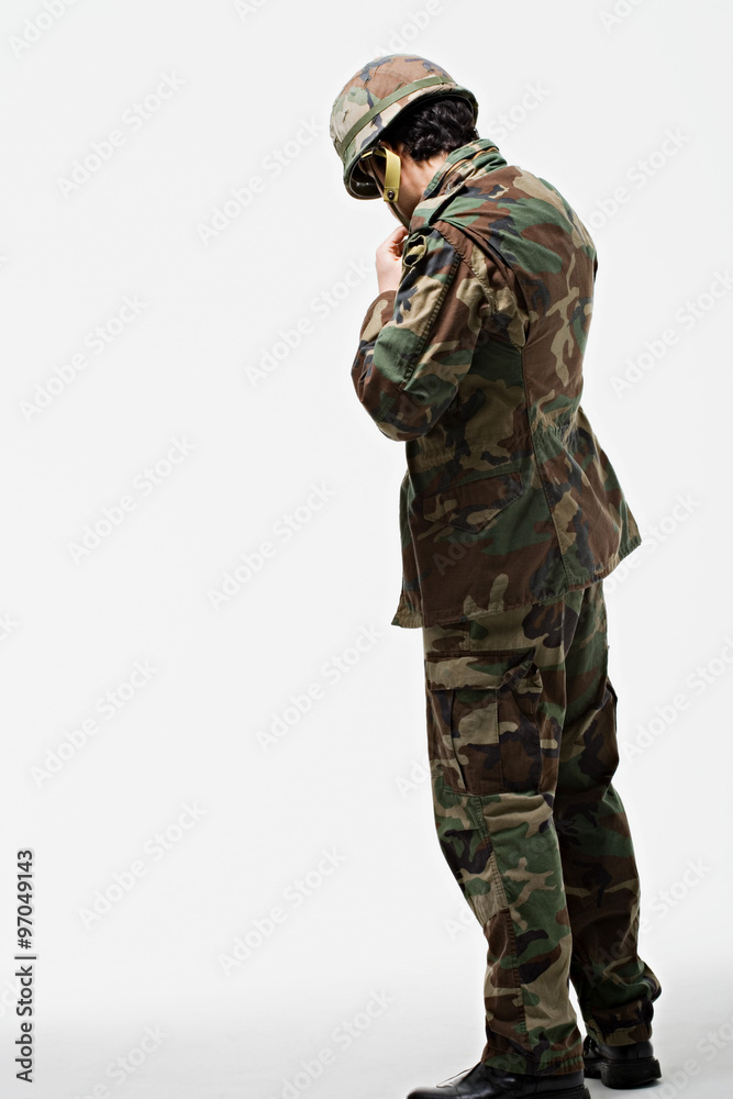 Soldier putting on helmet Soldier putting on helmet