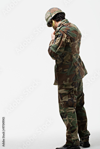 Soldier putting on helmet