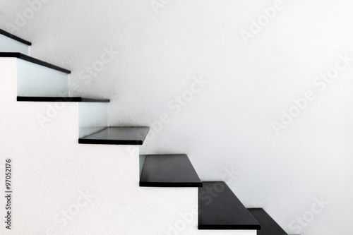 white wall stairs black wooden step