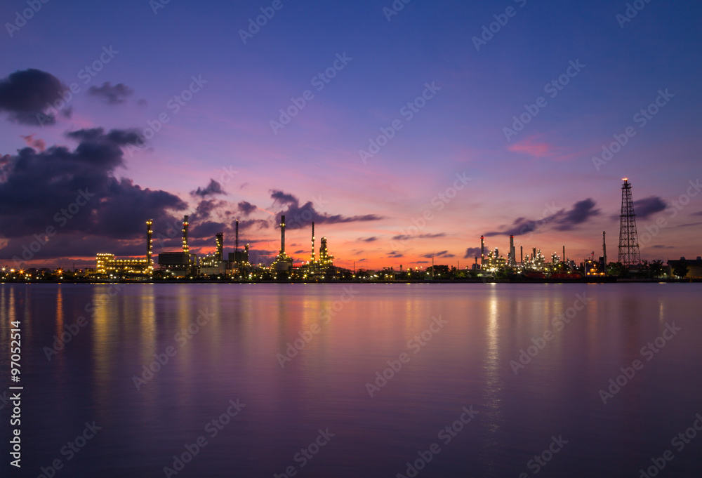 twilight sky over oil refinery powerplant reflection on water