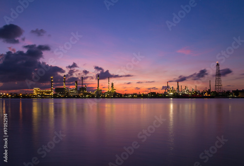 twilight sky over oil refinery powerplant reflection on water