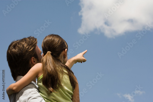 Father and daughter looking at cloud