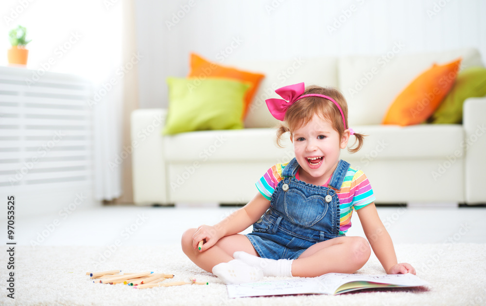 happy child girl drawing with colored pencils lying on floor happy child girl drawing with colored pencils lying on floor