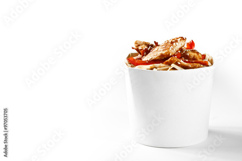 Delicious wok noodles box with chicken and udon. Chinese and asian takeaway fast food. Studio isolated with real shadow