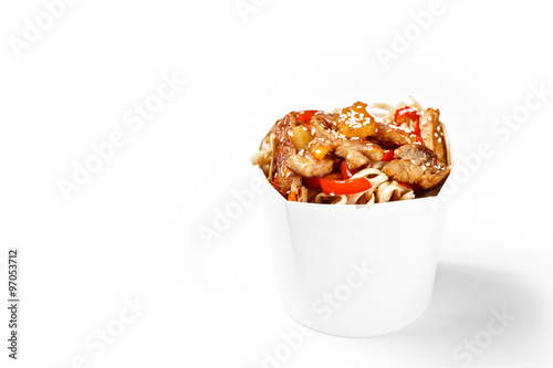 Delicious wok noodles box with sweet sauce chicken and udon. Chinese and asian takeaway fast food. Studio isolated with real shadow