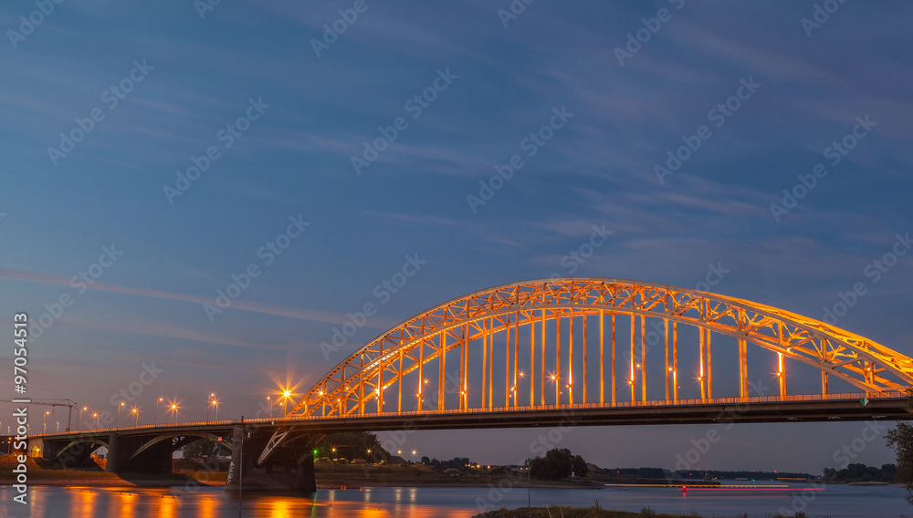 Obraz premium Light up bridge at sunset with twilight