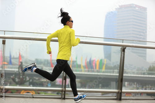young fitness woman runner running at shanghai city