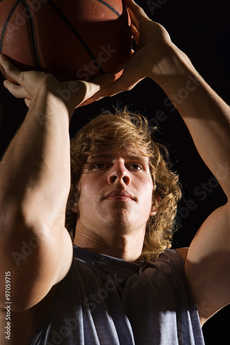 Young man aiming basketball