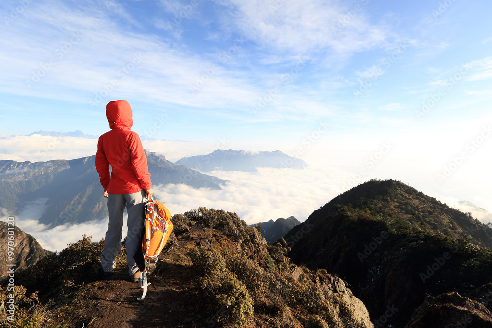 young woman backpacker hiking to beautiful mountain peak young woman backpacker hiking to beautiful mountain peak