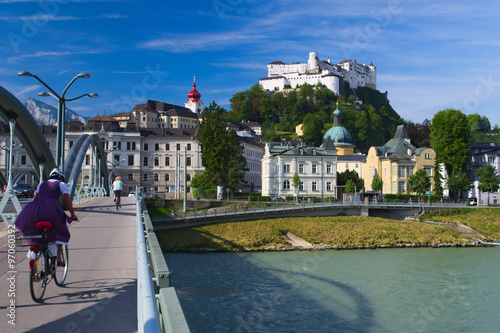 Girl on a bicycle crossing a bridge in Salzburg, Austria
